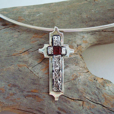 Cross in sterling silver with a garnet on a sterling silver wire