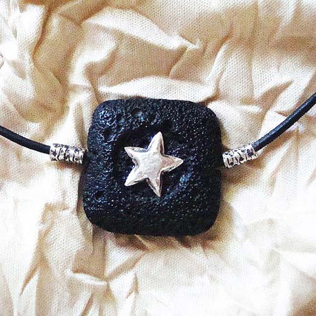Lava Stone Pendant with a sterling silver repousse star on a leather band